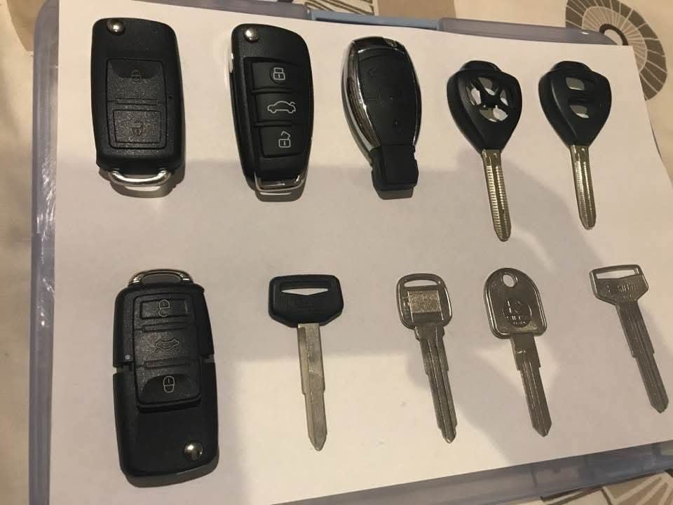 Assorted key blanks, flip keys and remotes laid out